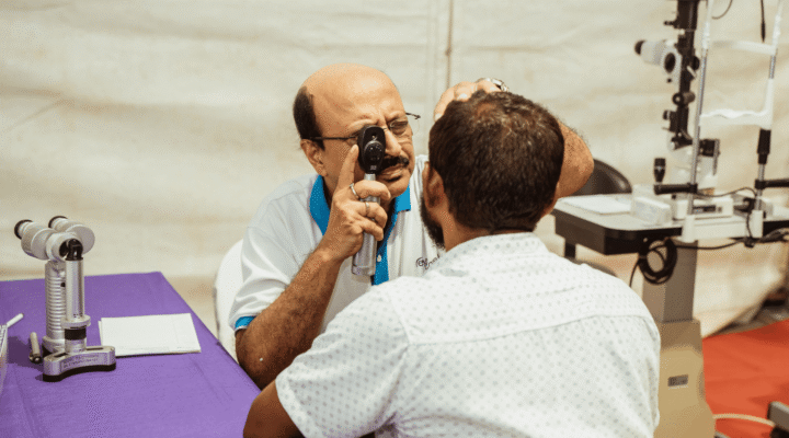 Eye doctor checking patient's vision during an eye examination