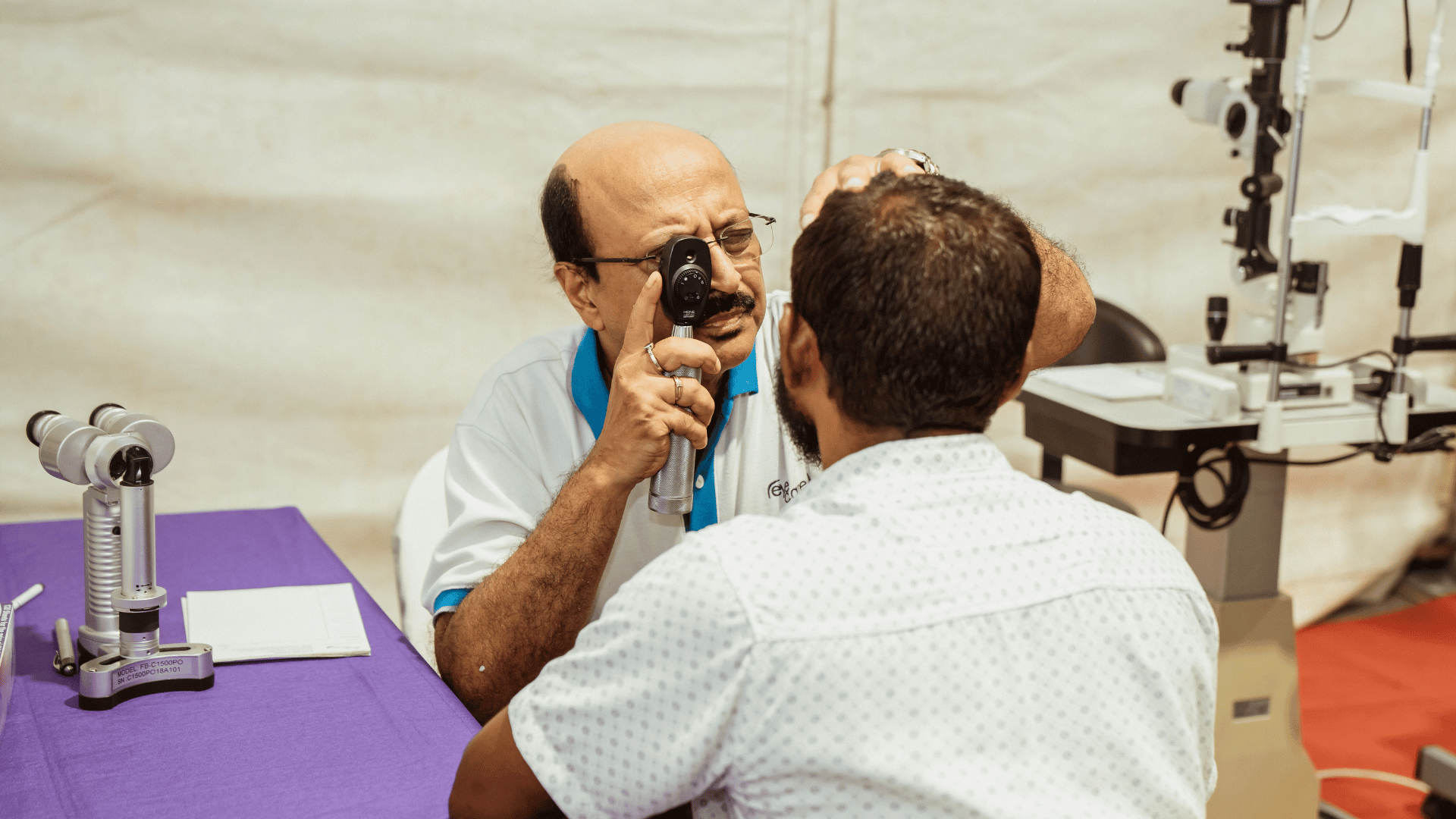 Eye doctor checking patient's vision during an eye examination